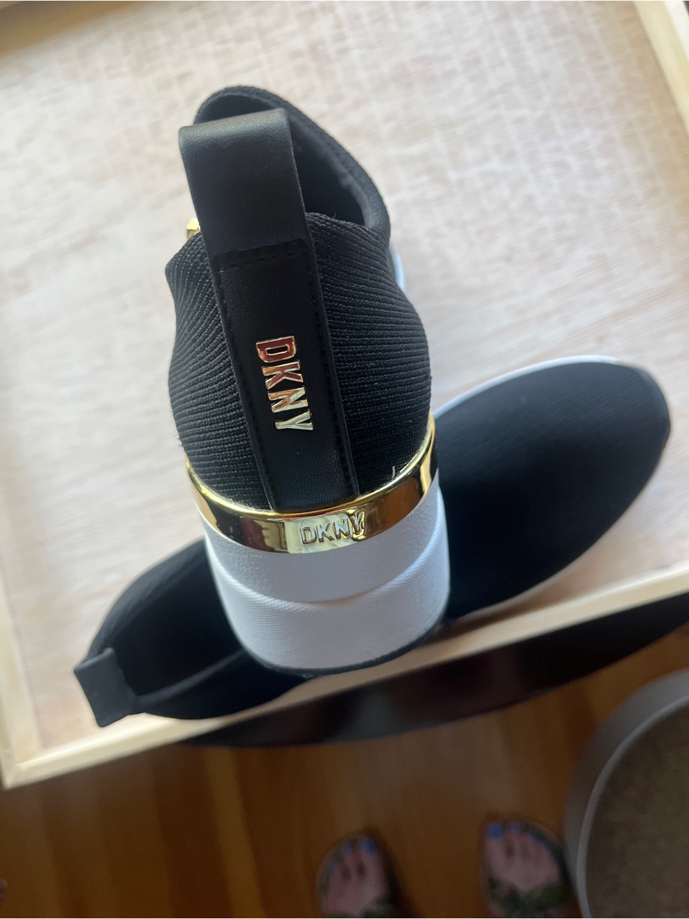 DKNY Black Slip-On Knit Sneaker with Gold Heel Band